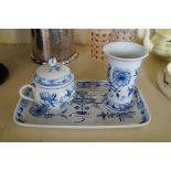 A Meissen porcelain blue and white three piece service, comprising spill vase, lidded pot and tray.