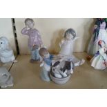 Three assorted Lladro and Nao figurines to include a girl washing her dog,