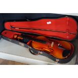 A cased violin with bow, the case label 'Hall Voigt of Manchester'.