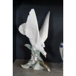 A Lladro figure of a perching dove.