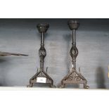 A pair of Arts and Crafts style cast metal candlesticks.