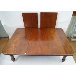 A Victorian mahogany wind action extending dining table with three extra leaves and winder The