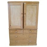 A Victorian stripped pine wardrobe The plain cornice above two panelled cupboard doors,
