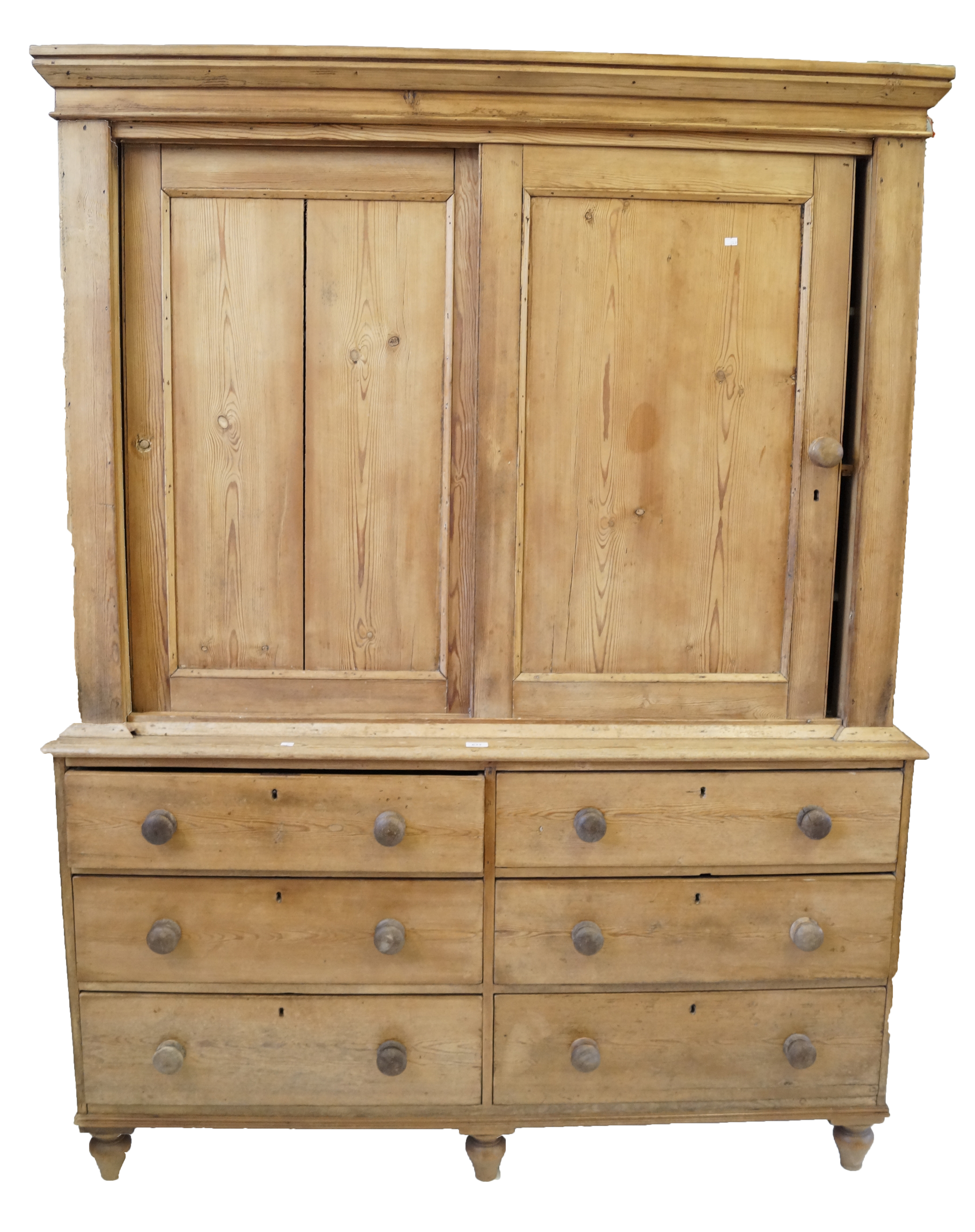 A Victorian stripped pine housekeeper's cupboard Featuring a moulded cornice above two sliding