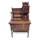 A carved oak writing cabinet,