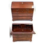 A George III mahogany bureau The hinged sloping fall front applied with brass oval escutcheon,