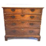 An 18th Century oak straight front chest of drawers The rectangular top with moulded over-hanging