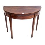 A George III mahogany semi circular tea table The hinged crossbanded top supported by rear twin