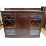 An Edwardian mahogany low bookcase The panelled central door flanked on either side by astragal