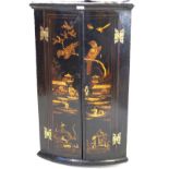 A highly decorative 18th Century lacquered bowfront hanging corner cupboard The two doors decorated