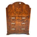 A stylish 1930s Art Deco figured walnut veneered bureau The cloud shaped top featuring a hinged