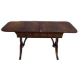 A Regency period ebony stung mahogany sofa table The rectangular top flanked by drop leaves with
