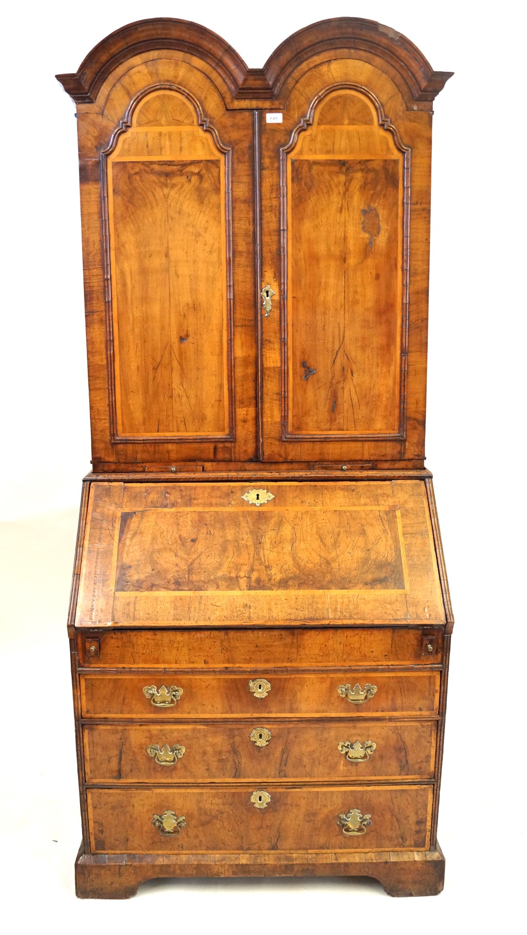 A fine George I walnut bureau bookcase The double domed top with two panelled,