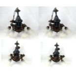 A harlequin set of four Victorian style bronzed spelter chandeliers Each having cast relief
