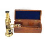 An early 20th Century travelling brass microscope With two extra lenses,