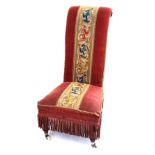 A Victorian prieu diu chair The mahogany frame with elongated scrolled back and low seat
