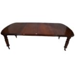 A Victorian mahogany extending dining table with two extra leaves and winder The rectangular top