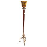 A stylish Period-style standard lamp The flared bell shaped brass uplight,