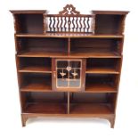 A late 19th Century British Arts & Crafts walnut bookcase Featuring an array of open fronted fixed