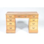 A late Victorian golden oak twin pedestal desk With a rectangular moulded top above three frieze