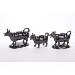 Three black Staffordshire cow creamers, late 19th, early 20th century Two with gilt decoration,