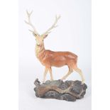 A Beswick model of a stag The twelve pointed stag standing on a naturalistic base, height 35cm.