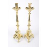 A good pair of brass candlesticks, 19th century The 39cm high candlesticks with drip tray,