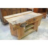 A 20th Century joiners work bench Having a plank top with a central channel,