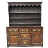 An exceptional 18th Century oak highback dresser The raised back with a moulded cornice above a