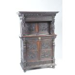 A late Victorian carved oak Flemish court cupboard The upper section with a lobed swept frieze