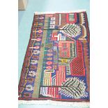 An Ethic design rug, 20th Century In vibrant shades of red and blue,