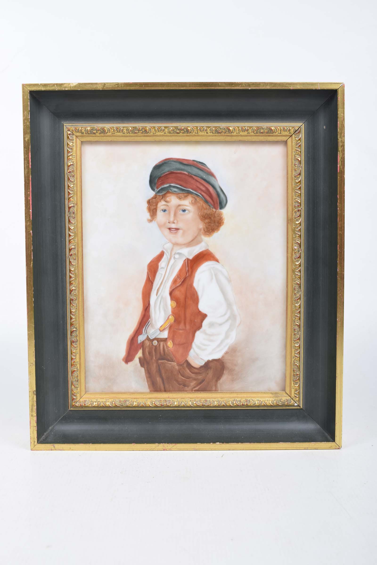 An early 20th Century painting on ceramic Depicting a young boy wearing a cap and a red waistcoat