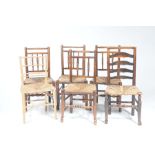 Four 18th/19th Century elm rush seat country chairs Each with a rail back above three turned