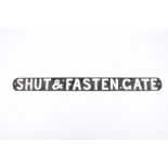 A rectangular iron sign "Shut and fasten Gate", with rounded ends and four screw holes, 85cm long.