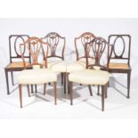 A set of four 19th Century Hepplewhite style mahogany dining chairs Each with an arched top rail