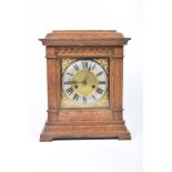 An early 20th Century oak cased bracket clock The case with a caddy top above two fluted columns