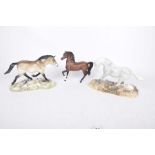 Three Beswick horse figures To include a Dunn example on a naturalistic plinth,
