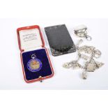 A silver charm bracelet With various charms attached to include a whale, a silver sovereign holder,