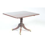 An early 19th Century mahogany centre table The rectangular moulded top supported on a knopped and