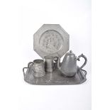 Five items of pewter To include early 20th Century two handled hammered tray, two tankards,