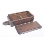 An oak wall-hanging storage box, mid-19th century Sliding lid to reveal two compartments,