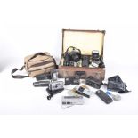 A collection of camera equipment To include a case with various lenses by Olympus, flash guns,