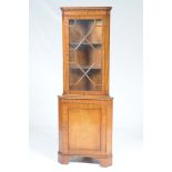 A good quality reproduction mahogany free standing corner cabinet by Bevan Funnell With a dentil