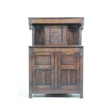 A 17th Century style carved oak court cupboard,