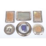 A collection of small silver photograph frames Of rectangular of circular form in varying sizes,