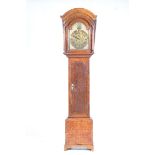 An 18th Century and later oak and mahogany cross banded longcase clock With a later arched pediment