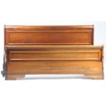 A reproduction mahogany sleigh bed With panelled foot and head boards of curved form raised on