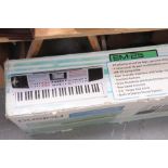 A boxed Roland EM25 keyboard and an Edwardian mahogany folding cake stand The keyboard with