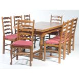 An 18th Century style medium oak drawer leaf refectory table and eight chairs,