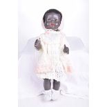 A black Pedigree doll With afro hair, open/shut orange eyes, red painted lips,